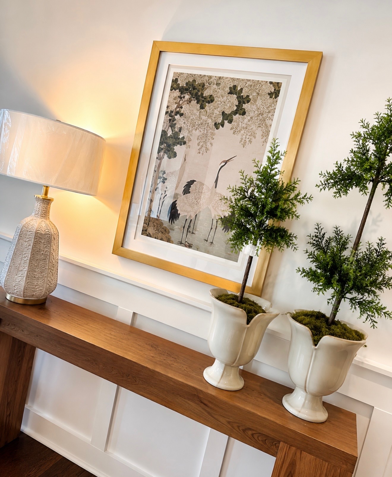 Entry console with crane art and topiaries