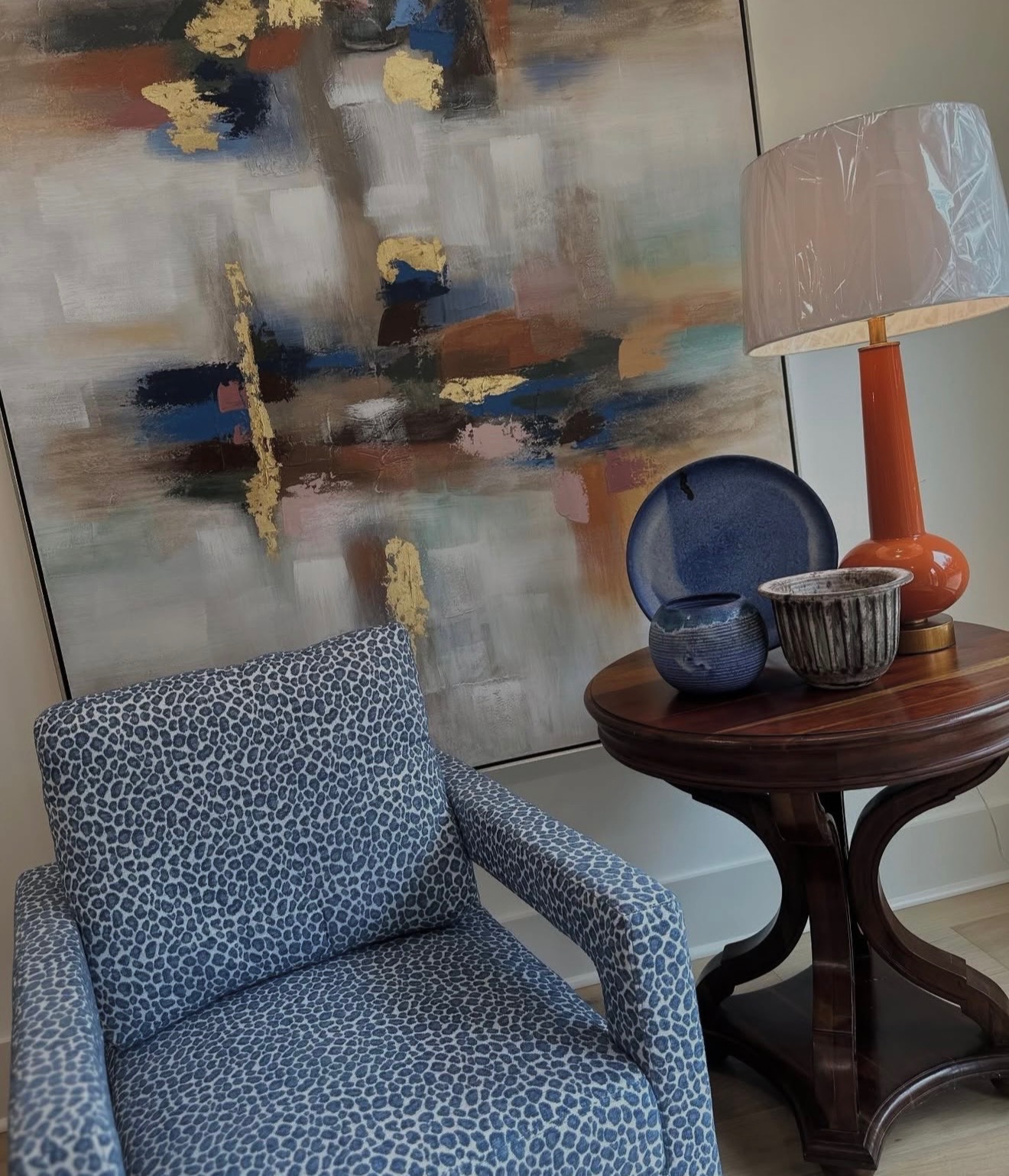 Blue leopard accent chair with abstract artwork