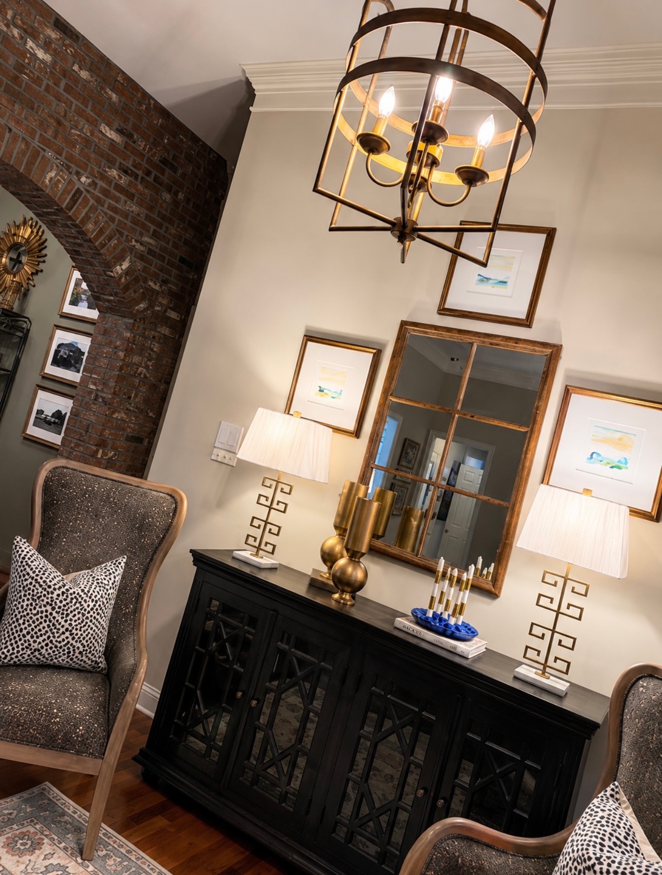 Dining room credenza with gold lamps and artwork gallery
